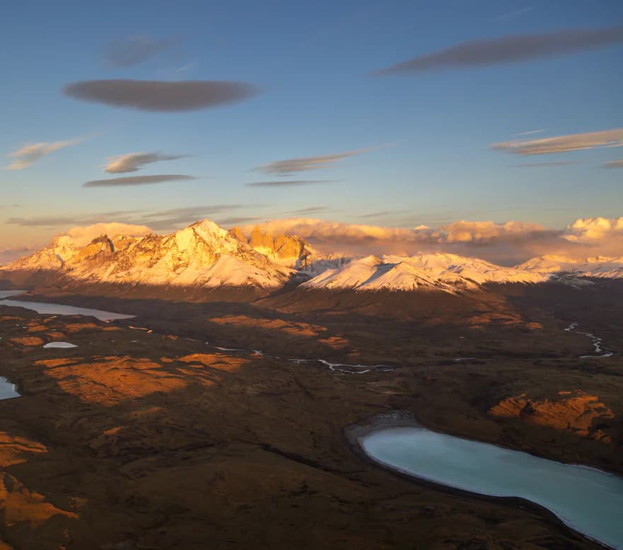 Turquoise lakes and golden hills seen from the air at sunset
