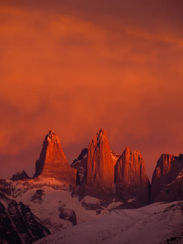 The towers glowing red under an ember sky