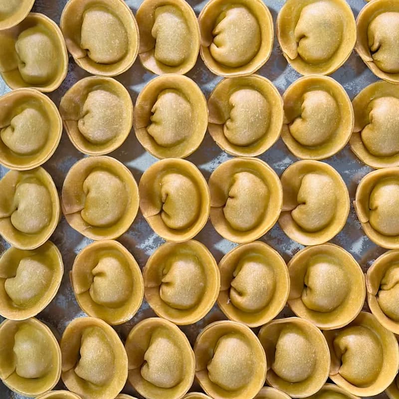 Rows of handmade pasta on a tray
